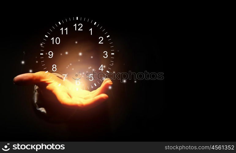 Time for business. Close up of businessman hand holding clock icon in palm