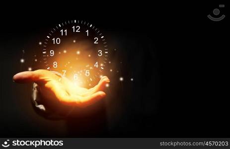 Time for business. Close up of businessman hand holding clock icon in palm