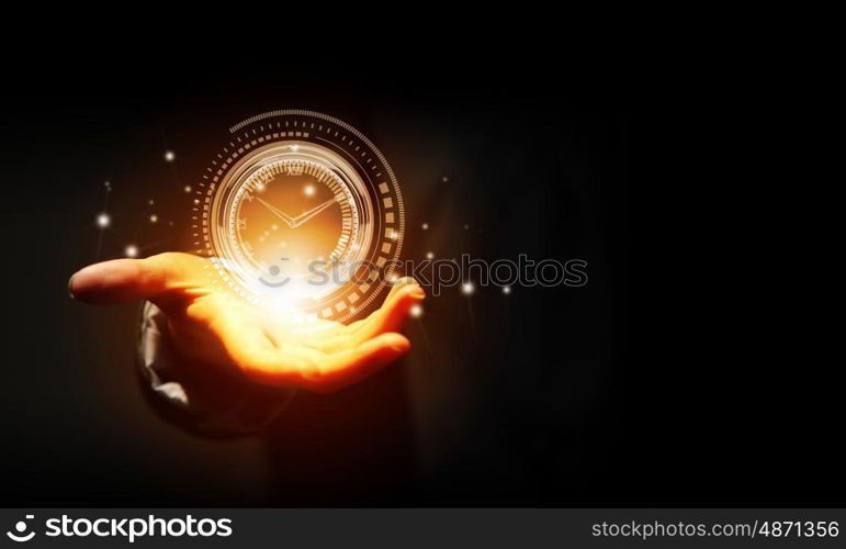 Time for business. Close up of businessman hand holding clock icon in palm