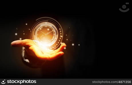 Time for business. Close up of businessman hand holding clock icon in palm