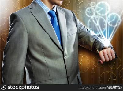 Time for business. Close up of businessman looking at watch at his wrist