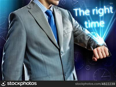 Time for business. Close up of businessman looking at watch at his wrist