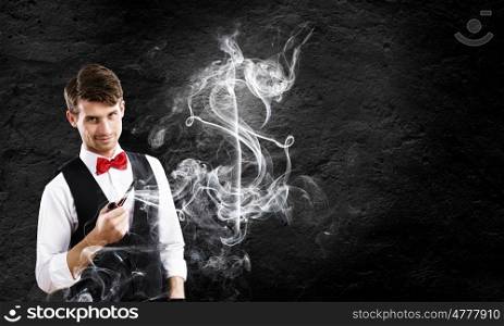 Time for business. Young handsome businessman smoking pipe. Money making