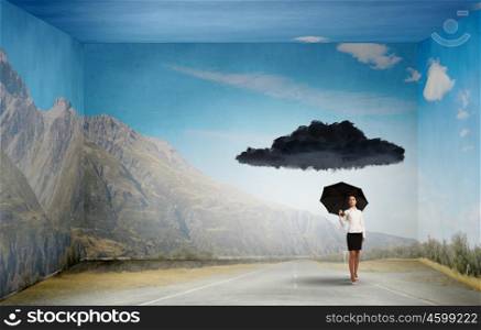 Time for challenge. Bad luck and crisis concept with young businesswoman with black umbrella