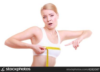 Time for diet slimming weight loss. Health care and healthy nutrition. Young fitness sad woman fit unhappy girl with measure tape measuring her bust size chest isolated on white