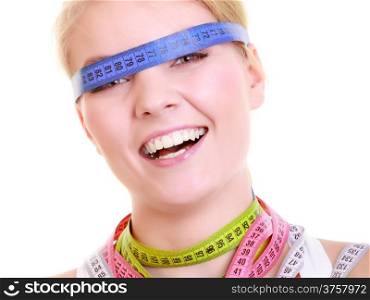 Time for diet slimming weight loss. Health care healthy lifestyle. Fit fitness woman with a lot of colorful measure tapes around her head. Obsessed girl by body.