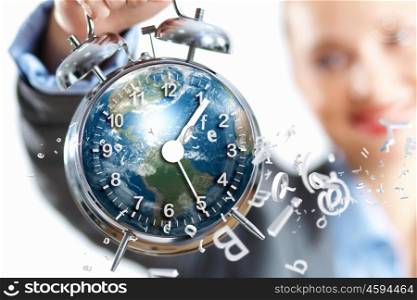 Time in business. Time in business illustration with clock in hands of businesswoman. Elements of this image are furnished by NASA