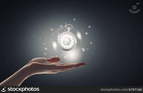 Time in our hands. Close up of businessman hand holding pocket watch in hand