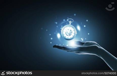 Time in our hands. Close up of businessman hand holding pocket watch in hand