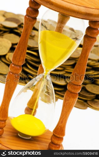 Time is money concept - hourglass and coins