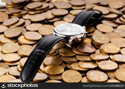 Time is money concept with watch and coins