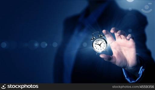 Time is passing. Close up of businessman hand showing clock watch symbol
