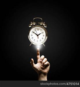 Time is passing. Close up of man hand pointing at clock watch
