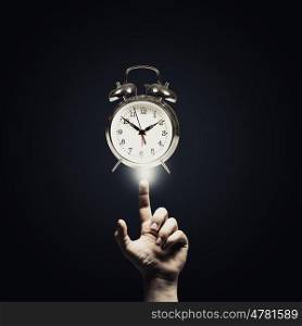 Time is passing. Close up of man hand pointing at clock watch symbol