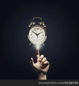 Time is passing. Close up of man hand pointing at clock watch symbol