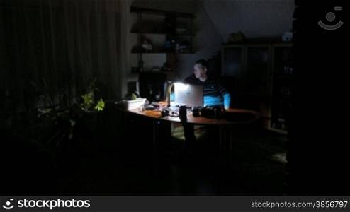 time lapse. man works on computer at night.
