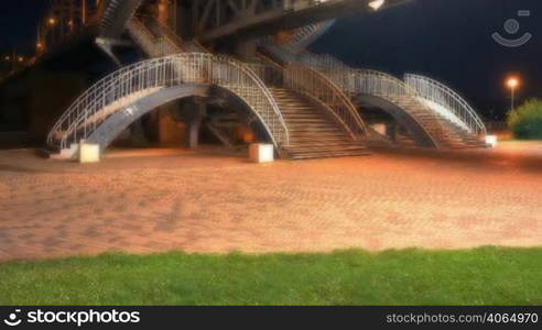 time lapse. Night. Steps on foot bridge.