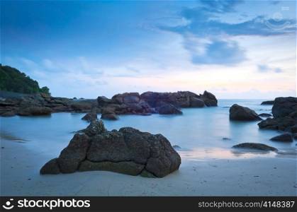 Time-lapse of beach at dusk with rocks
