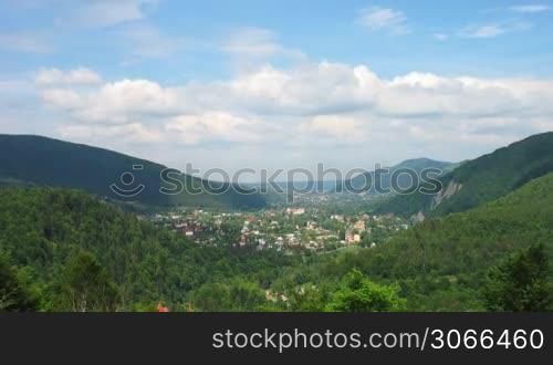 time lapse of Carpathian Mountains and small village between