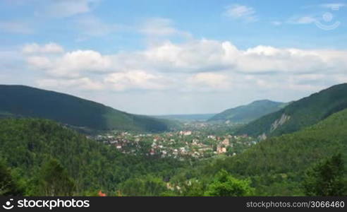 time lapse of Carpathian Mountains and small village between