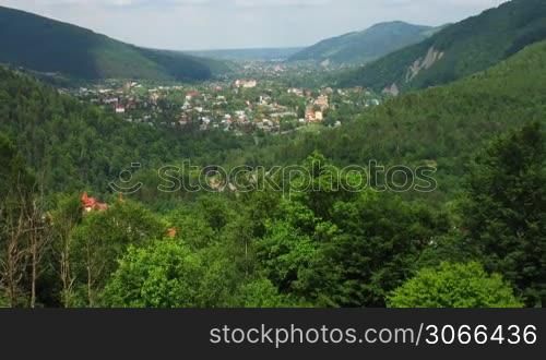 time lapse of Carpathian Mountains and small village between, panorama