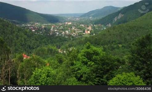 time lapse of Carpathian Mountains and small village between, panorama
