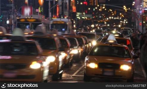 Time lapse of city traffic and pedestrians at night, shot in Times Square, New York City