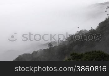 Time lapse of clouds crossing over mountain in the rain.