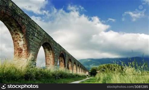 Time-lapse of clouds near the aqueduct and the mountains views in Italy, Tuscany