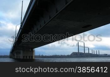 time lapse of cloudy sky and automobile bridge.