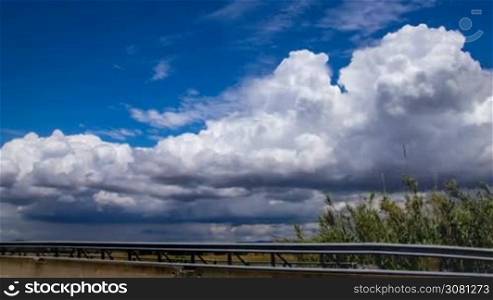 Time-lapse of cloudy sky next the highway in Italy, Tuscany