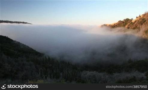 Time lapse of fog rolling in over the hills at the Big Sur in California