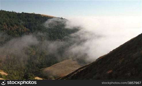 Time lapse of fog rolling in over the hills at the Big Sur in California