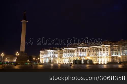 Time lapse of people walking on Palace Square with illuminated General Stuff Building and Alexander Column, St. Petersburg, Russia.