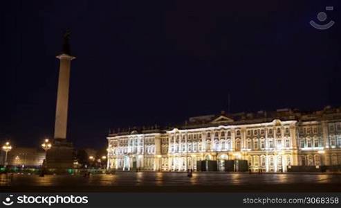 Time lapse of people walking on Palace Square with illuminated General Stuff Building and Alexander Column, St. Petersburg, Russia.
