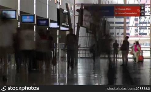Time Lapse of people with luggage, walking and checking in at an airport