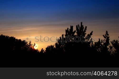 time lapse of running clouds on sunset in forest. no birds and free of defects.