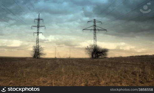 time lapse of running clouds with electricity pylon.