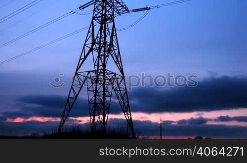 time lapse of running clouds with electricity pylon.