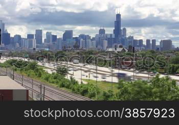 Time lapse of the busy Kennedy Expressway traffic with clouds rolling over the Chicago skyline