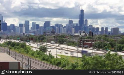 Time lapse of the busy Kennedy Expressway traffic with clouds rolling over the Chicago skyline
