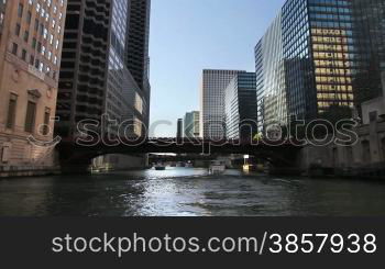 Time lapse shot from a boat as it passes underneath bridges and past the skyscrapers of Chicago on the Chicago River