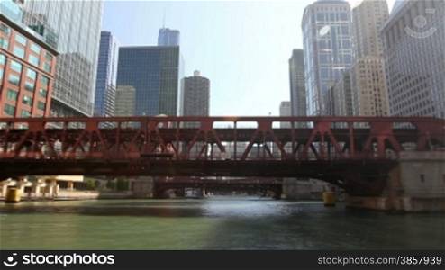 Time lapse shot from a boat as it passes underneath bridges and past the skyscrapers of Chicago on the Chicago River