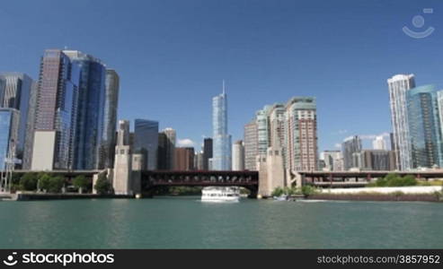 Time lapse shot with a smooth motion view from a boat as it enters the mouth of the Chicago River, passing under bridges and through skyscrapers into the center of Chicago