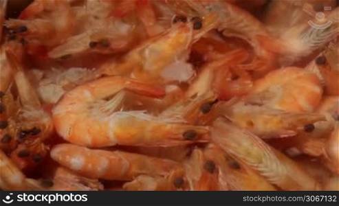 Time lapse. Shrimp are simmered in a saucepan.