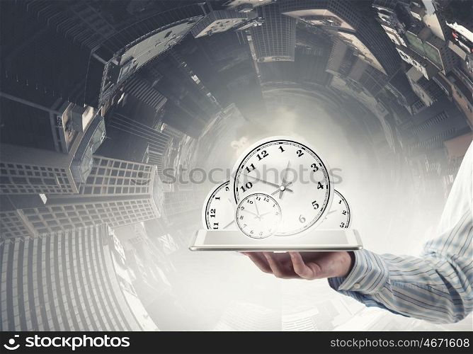 Time management. Businessman hold tablet pc with clocks on screen