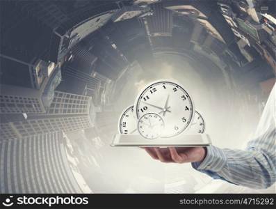 Time management. Businessman hold tablet pc with clocks on screen