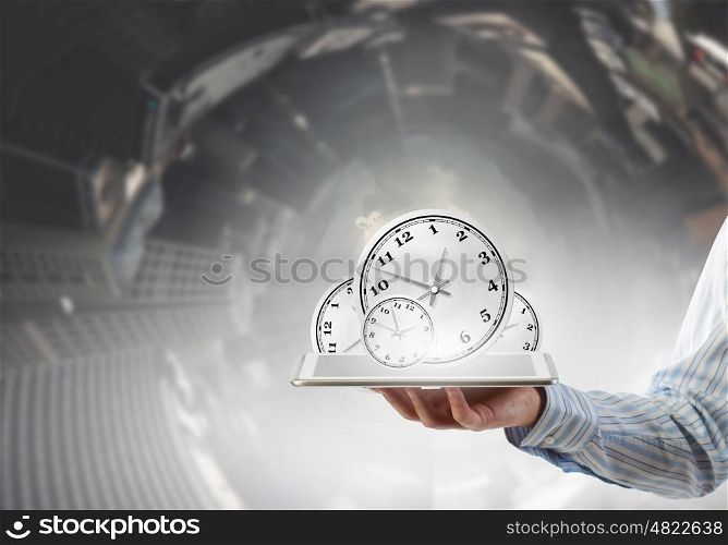Time management concept. Businessman hold tablet pc with clocks on screen