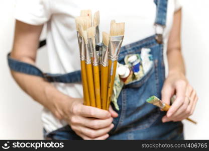 time of creativity. girl painter holds a brush
