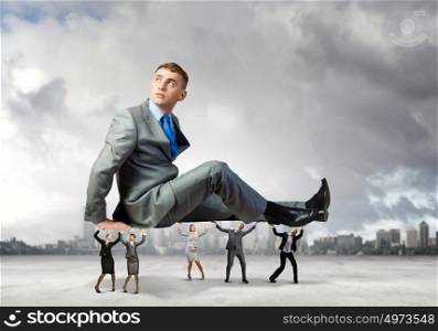 Time out. Young relaxed businessman supported by business colleagues